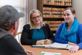 Attorney and paralegal listening to a client