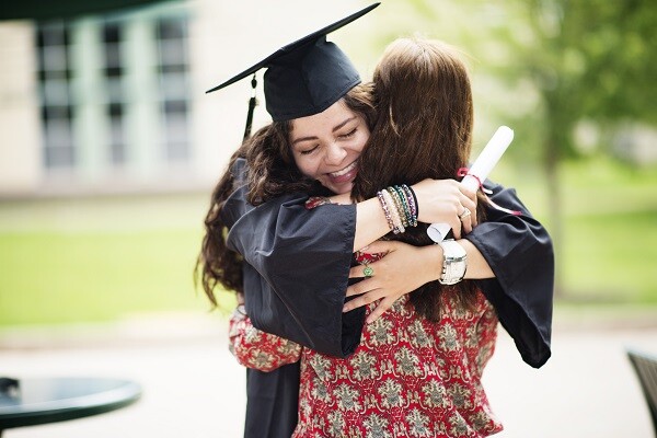 girl hugging mom at graduation