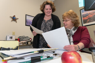 Two women reviewing documents together